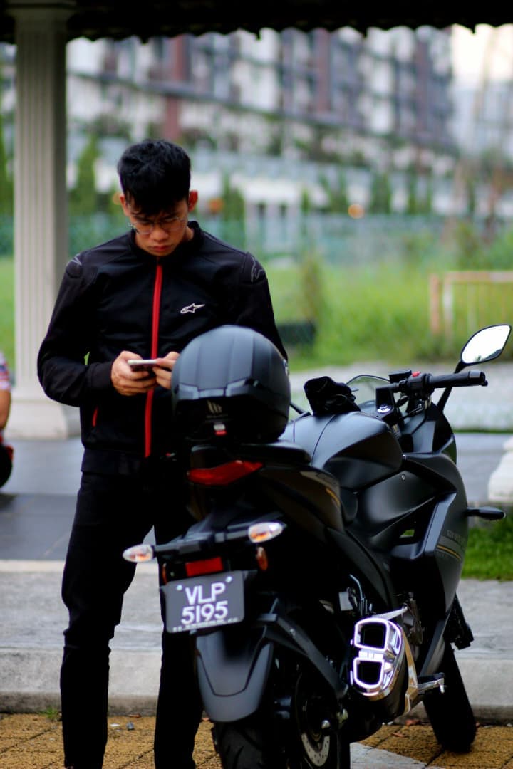 A picture of a fine young with his ride